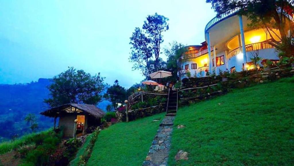 a building on the side of a green hill at The - Hideaway Ella in Ella