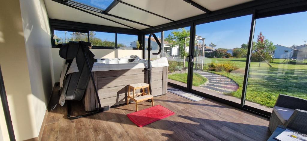 a bathroom with a tub and a sink on a deck at Fleur Du Ciel Vendée in Challans