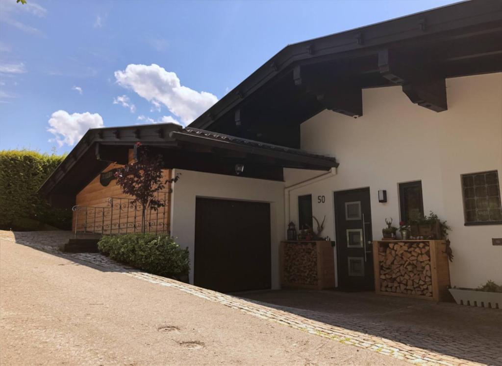a house with a black roof and a garage at Landhaus Osttirol in Iselsberg