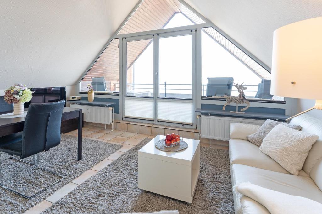 a living room with a couch and a table at Strandburg Ostseeblick Scharbeutz in Scharbeutz