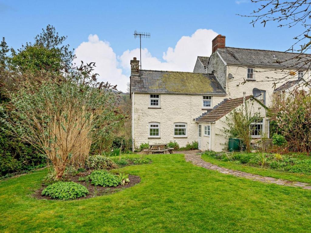 an old house with a garden in front of it at 2 Bed in Crickhowell oc-bn052 in Llangynidr