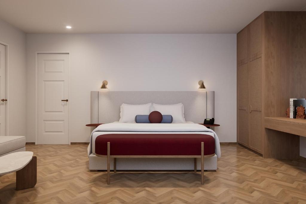 a bedroom with a large bed with a red blanket at The Character in Athens