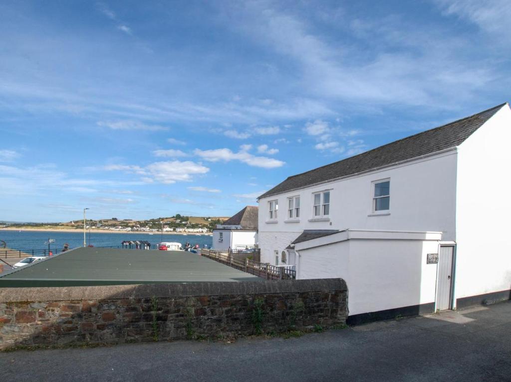 a white building with a basketball court next to the water at 4 Bed in Bideford oc-86776 in Appledore