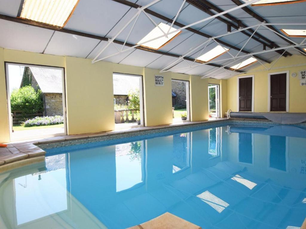an indoor swimming pool with blue water at 3 Bed in Abergavenny oc-90233 in Llanvetherine