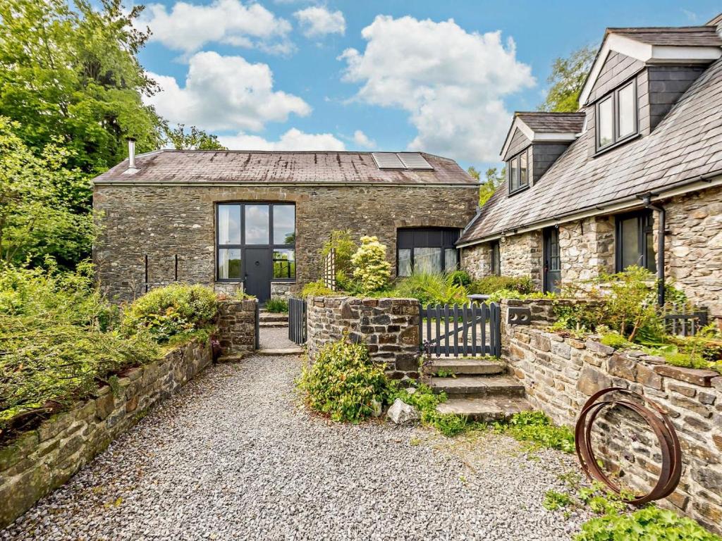 an old stone house with a stone wall at 3 Bed in Llandovery oc-bn093 in Llandovery