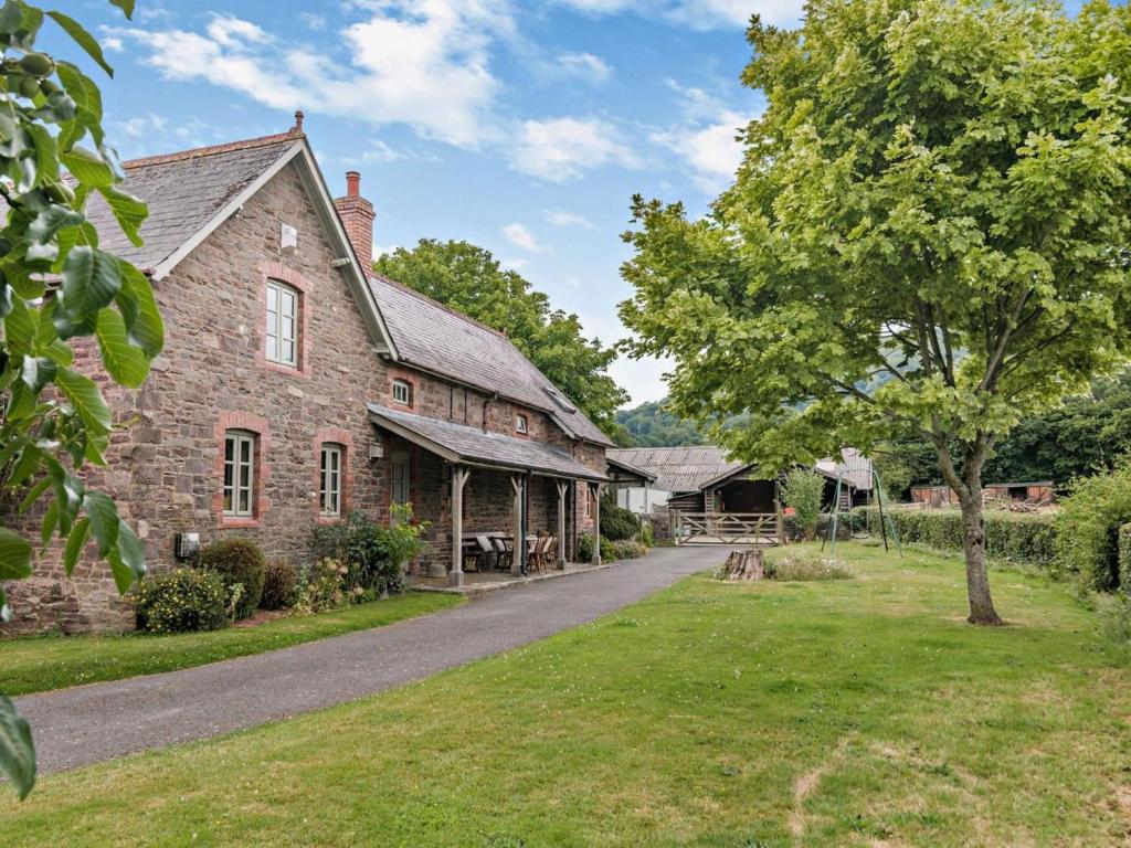an old brick house with a road in front of it at 2 Bed in Brecon oc-bn281 in Llanhamlach