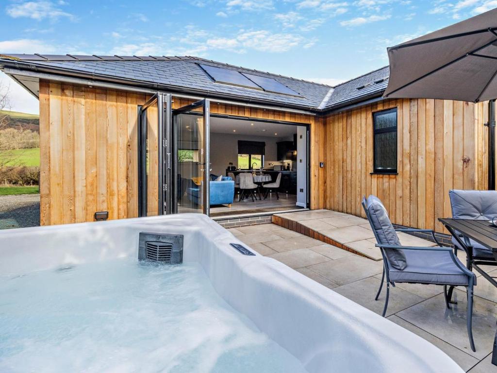 a hot tub in the backyard of a house at 2 Bed in Knighton oc-94203 in Knighton