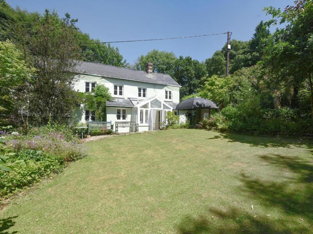 a white house with a large yard at 4 Bed in Barnstaple oc-73949 in Stoke Rivers