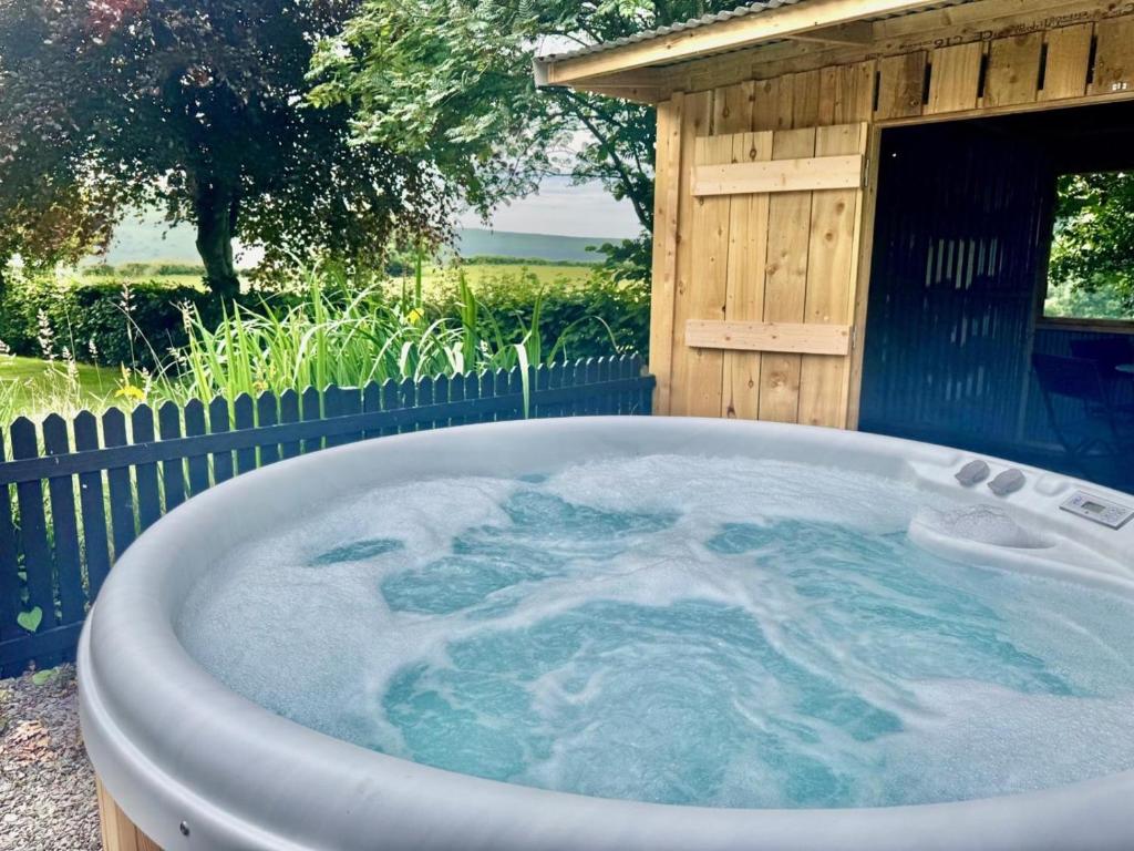 a jacuzzi tub in front of a building at 2 Bed in Builth Wells oc-bn201 in Aberedw