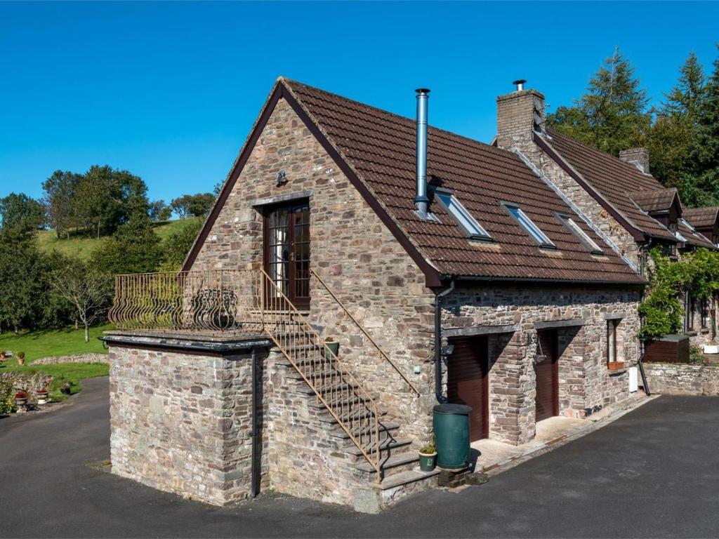 an old brick house with a staircase on it at 2 Bed in Brecon oc-bn077 in Llandefaelogfâch