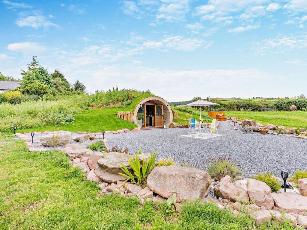 a garden with a circular building with a patio at 1 Bed in Brecon oc-95630 in Aber-Brân