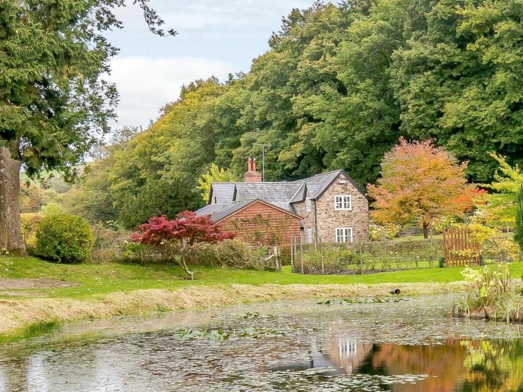 a house with a pond in front of it at 3 Bed in Presteigne oc-78336 in Evenjobb