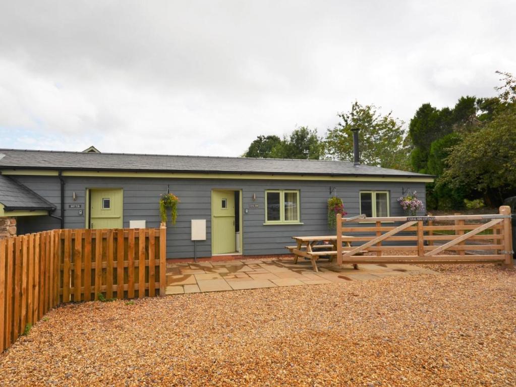 a house with a wooden fence in front of it at 2 Bed in Pontypool oc-58962 in Mamhilad