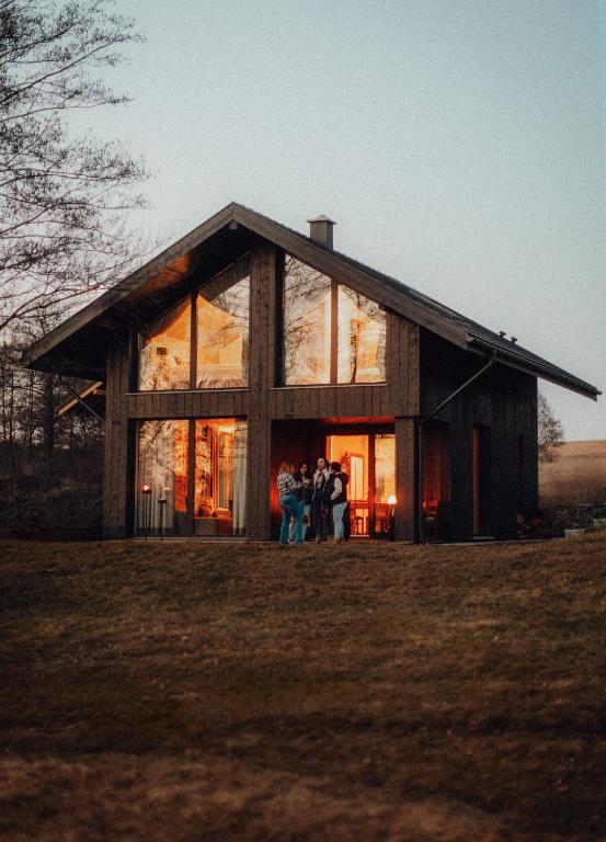 a group of people standing in front of a house at CHATY U HARREGO NAD STAWEM SPA sauna, balia, rowery, klimatyzacja, in Kudowa-Zdrój