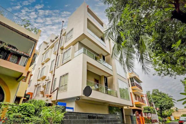 a large white building with a balcony on a street at Shubhham Regency in kolkata