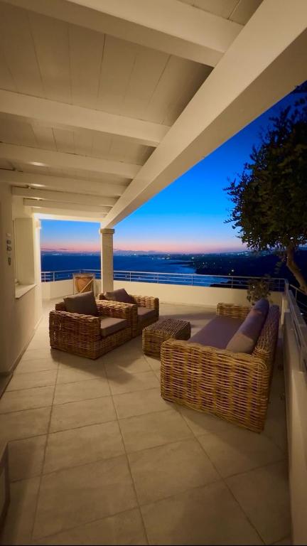 a balcony with couches and a view of the ocean at Villa La Gioia in Terra Mala