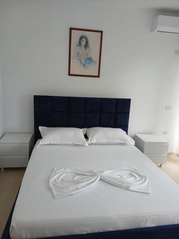 a large white bed with a bow on it at Amaris-Kian Tragaj Apparent in Vlorë