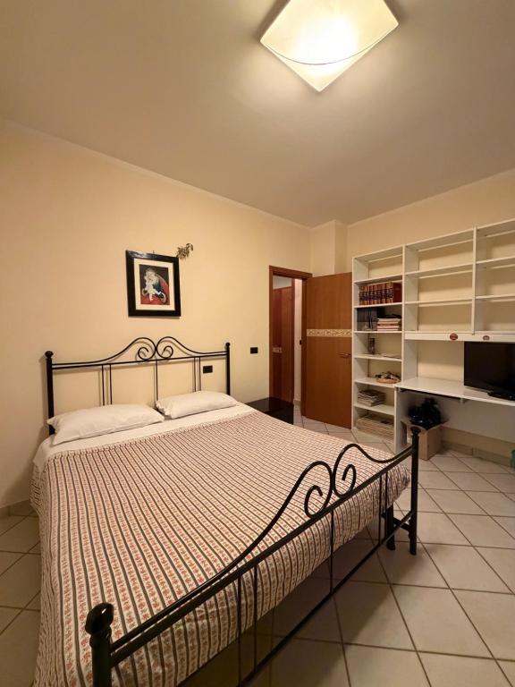 a bedroom with a bed and a television in it at Guest House Colfiorito by Ospitaci in Colfiorito