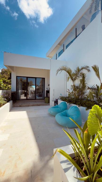 a patio with blue bean bags in front of a house at Tris Villa 3 in Bumbang