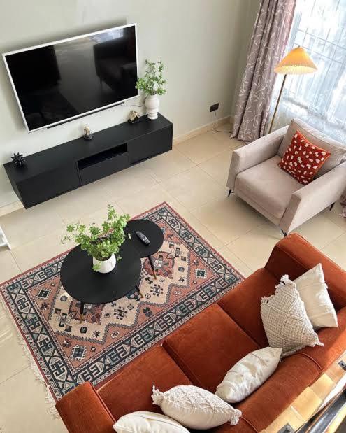 a living room with a couch and a table at New Dawn luxury homes in Nairobi