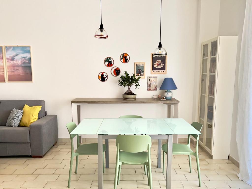 a dining room with a table and chairs at Casa Camilla in Lido di Fermo