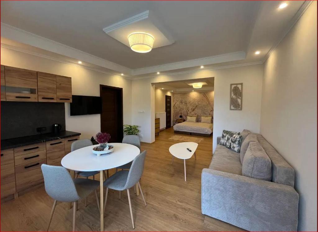 a living room with a table and a couch at Przystanek Rozkochów in Rozkochów