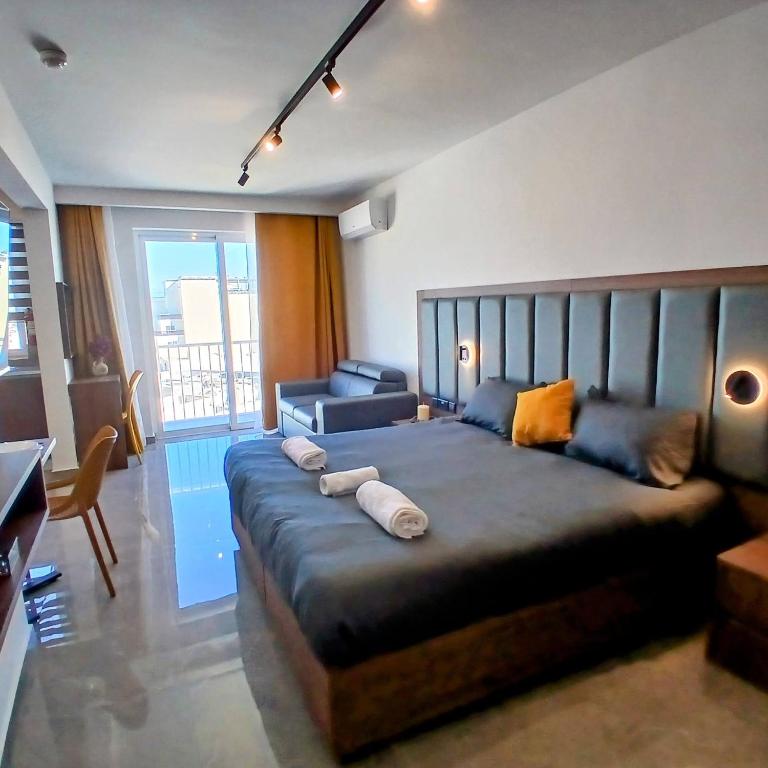 a bedroom with a large bed with pillows on it at The Black Onyx in Il-Gżira