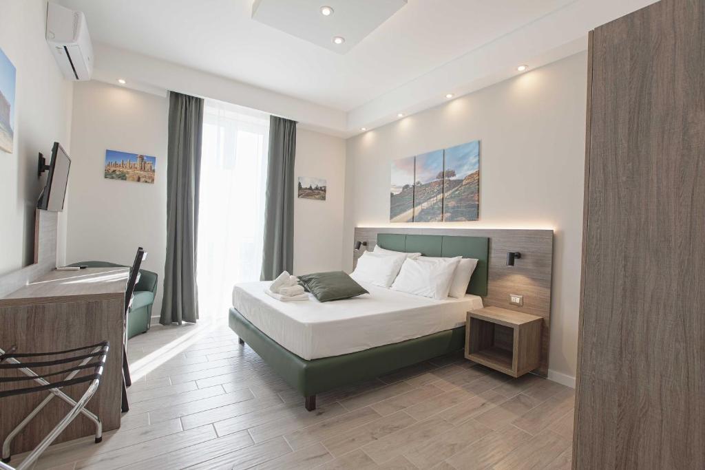 a bedroom with a bed and a desk in it at B&B Sikelia Suite in Agrigento