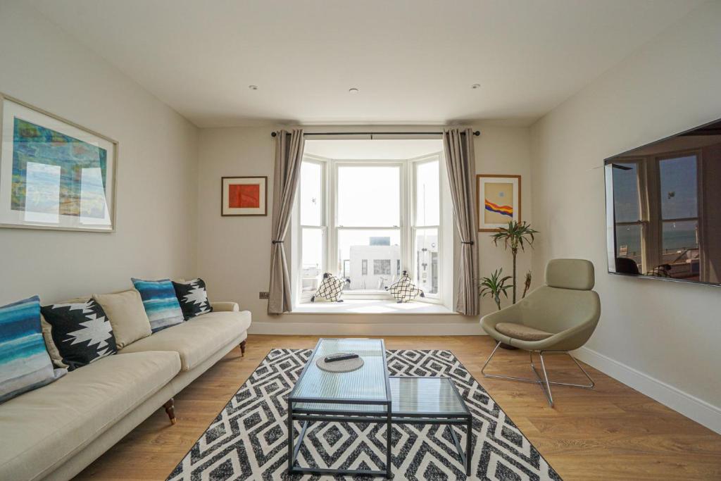 a living room with a couch and a table at 1 White Rock Heights in Hastings