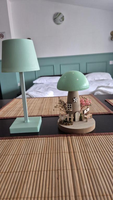 a bed with a table with a lamp and a toy house at Aparthotel Metropol in Iaşi