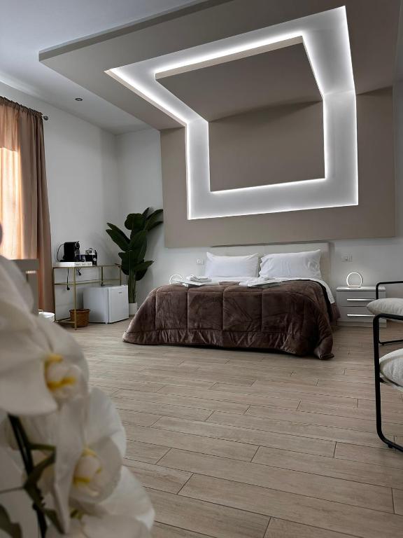 a bedroom with a bed and a large mirror at Centrale Suites in Brindisi