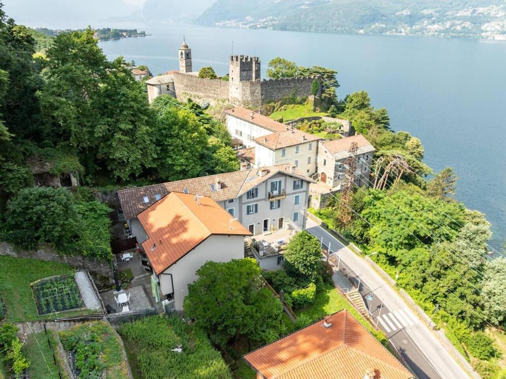 an aerial view of a town on a hill next to the water at Castelaus, Lake view, 1 Min Walk from the Lake in Dervio