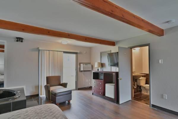 a living room with a bed and a living room with at Maplehurst Motel in Tunkhannock