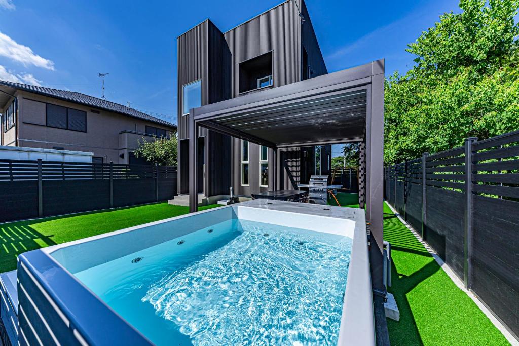 a swimming pool in the backyard of a house at Galaxy Pool Resort in Takashima