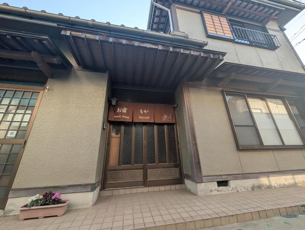 a building with a sign on the front of it at お宿&カフェバーもか in Higashikagawa