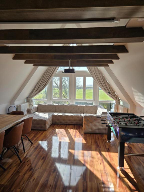 a living room with a couch and a table at Loft Linda in Sylt
