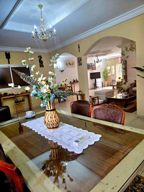 a living room with a vase of flowers on a table at Providence Guesthouse and Catering Services in Abidjan
