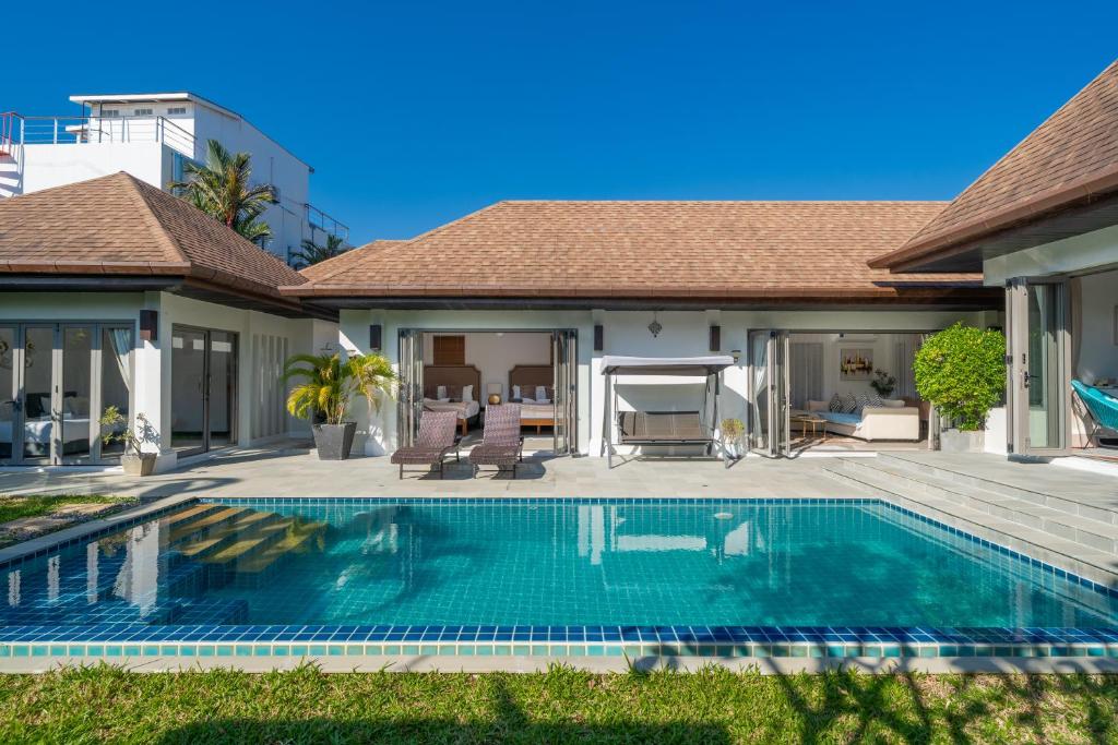 a swimming pool in the backyard of a house at Nivara Pool Villa - Rawai in Rawai Beach