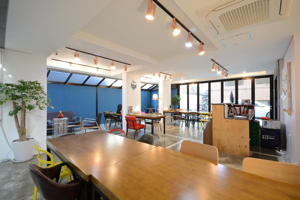 an office with a large wooden table and chairs at Sunnyhill Hostel Hongdae in Seoul