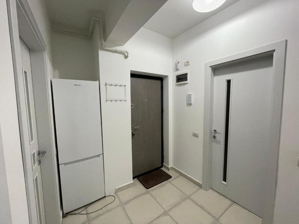 a hallway with white walls and a door at Apartament cu 2 camere decomandate in Roşu