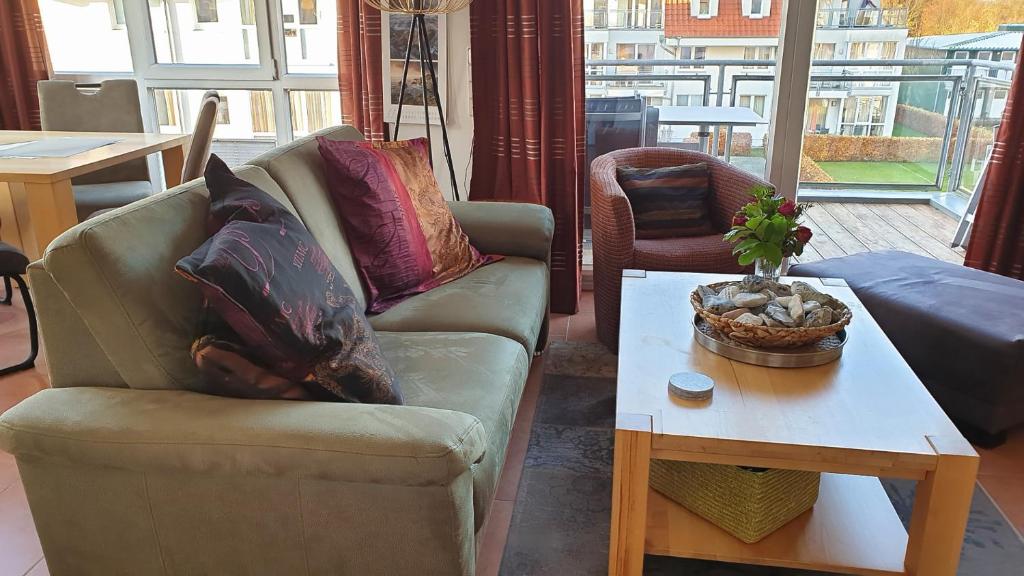 a living room with a couch and a coffee table at Meerblick 9 - Großenbrode in Grossenbrode