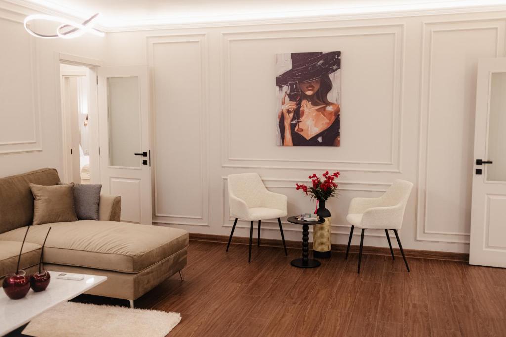a living room with a couch and a painting on the wall at Central Premium Suites in Plovdiv