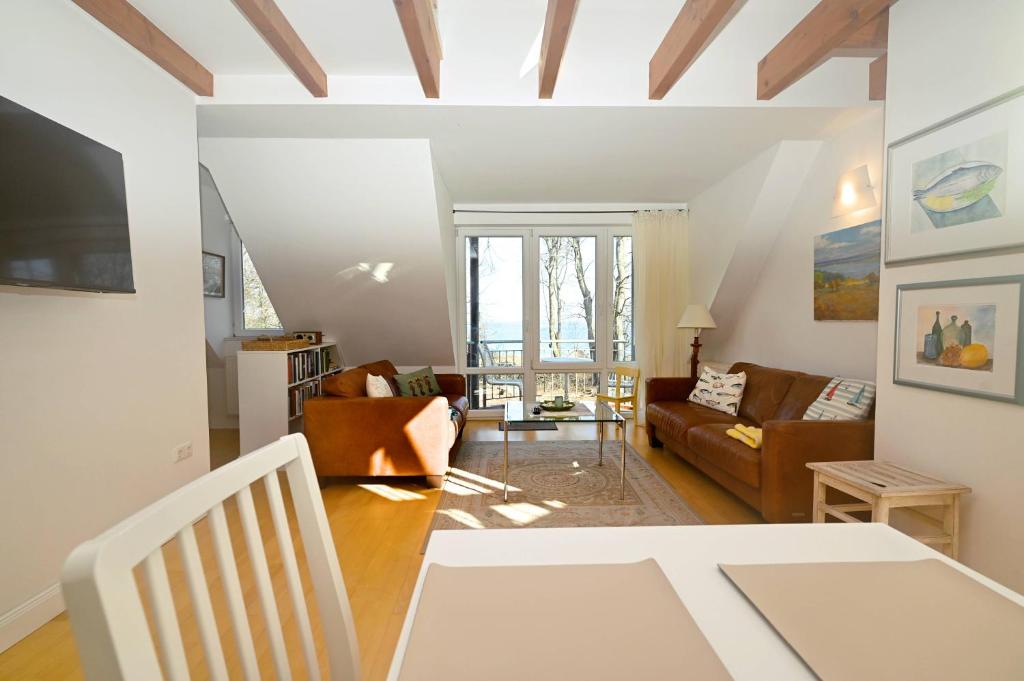 a living room with a couch and a table at Appartement Moin! in Hohwacht