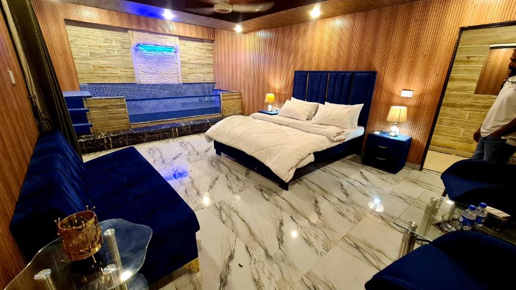 a bedroom with a bed with a marble floor at Hotel Five Rivers - 2 Min to Allama Iqbal International Airport, Lahore in Lahore