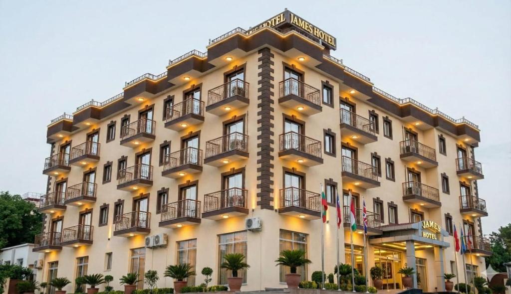 a large white building with balconies on it at James Hotel & Apartments in Juba