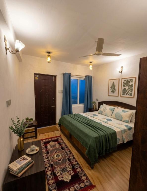 a bedroom with a bed and a table in it at Batohi hotel cafe & Restaurant in Devaprayāg