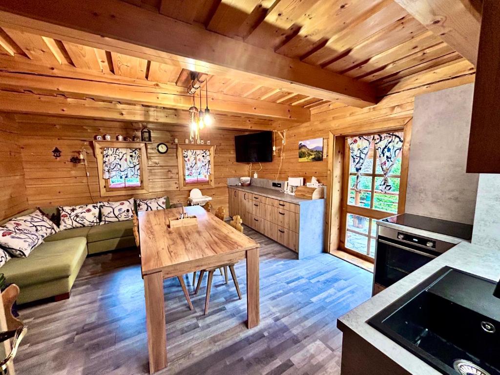 a living room with a couch and a table at Chatka pod orechom in Terchová