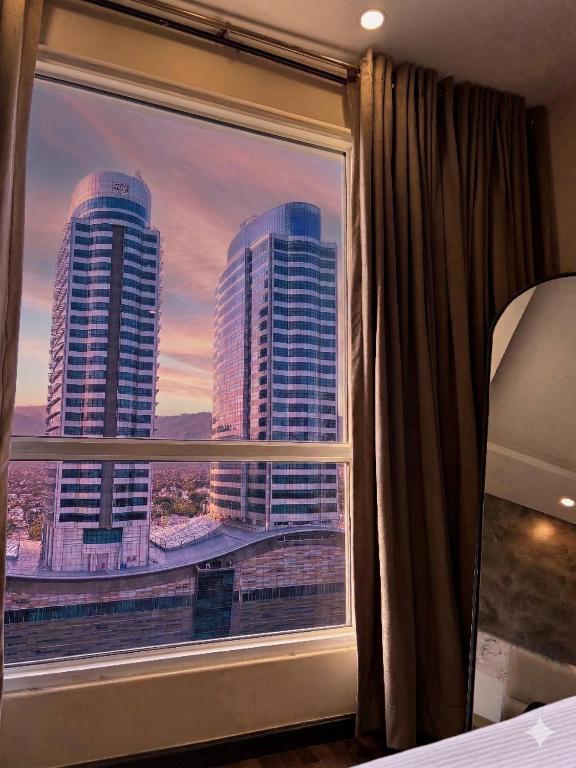 a bedroom window with a view of a city skyline at Elysium Premium Centaurus View in Islamabad