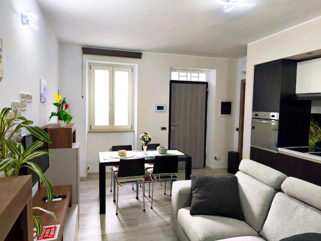 a living room with a table and a couch at Casa Ramalma Estate in Brianza Appartamento tra Milano Monza e Como con self check-in in Seveso