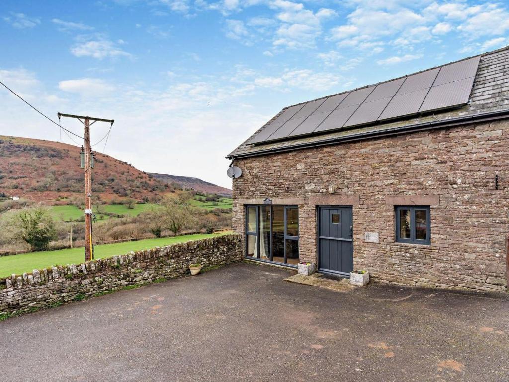 a brick building with solar panels on its roof at 2 Bed in Crickhowell oc-mawrw in Cwm-du